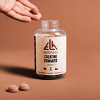 Bottle of ELK Wellness Creatine Gummies on a brown background