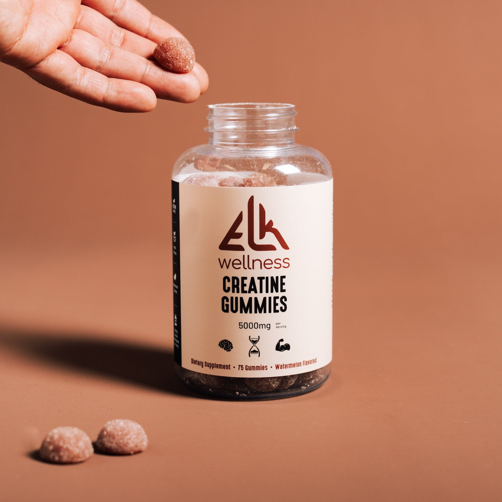 Bottle of ELK Wellness Creatine Gummies on a brown background